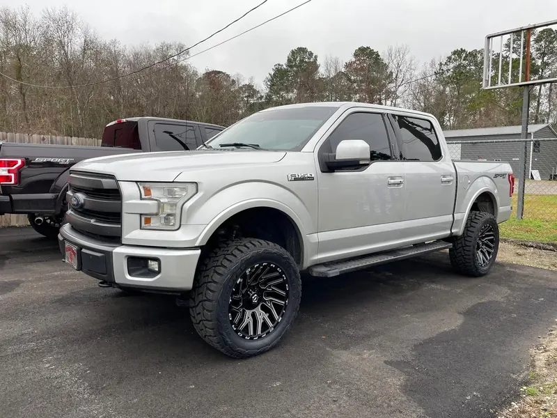 Silver Ford F-150 with a 4-inch Rough Country lift, 20-inch wheels and Toyo tires
